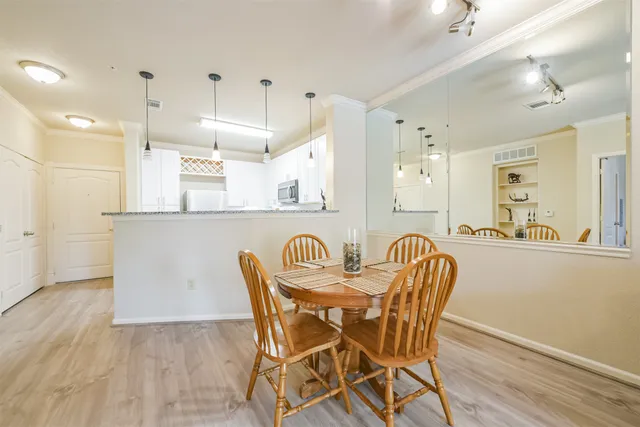 a view of a dining room with furniture and wooden floor