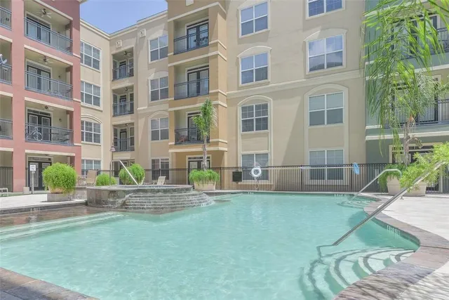 a view of a patio with plants and chairs