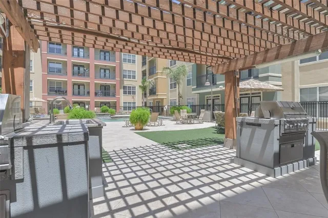 a view of a patio with table and chairs and potted plants