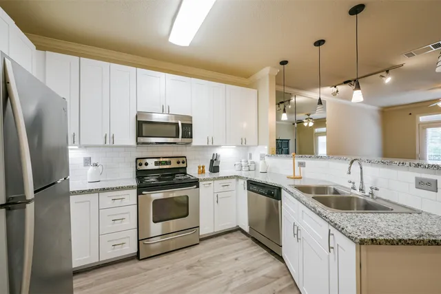 a kitchen with a sink stove and refrigerator
