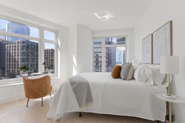 a bedroom with a bed and a large window