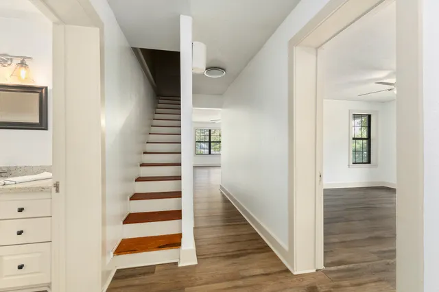 a view of a hallway with wooden floor and entryway