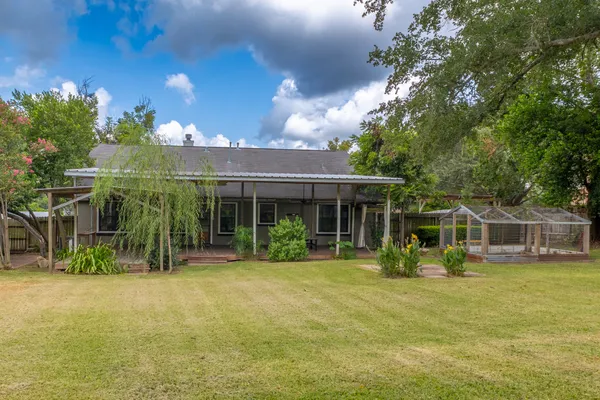a view of a house with backyard porch and sitting area