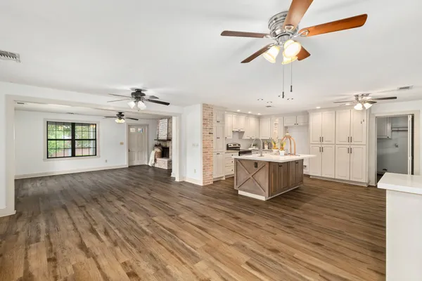 a view of kitchen and hall with wooden floor
