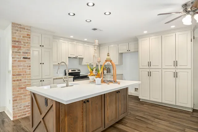 a kitchen with a sink stainless steel appliances and white cabinets