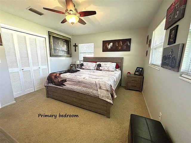 a bedroom with a bed dresser and a window