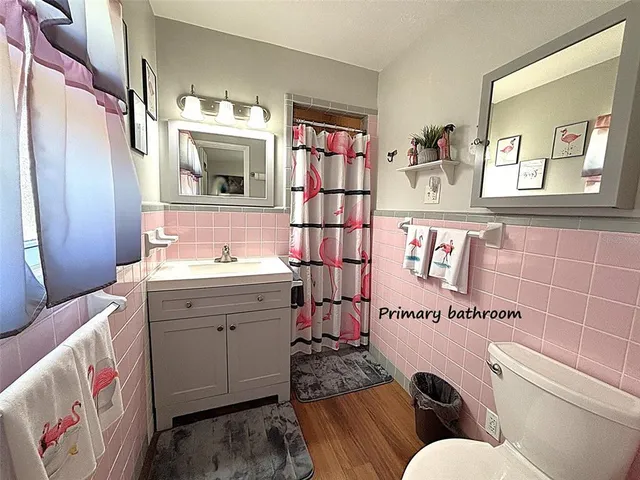 a bathroom with a sink mirror and toilet