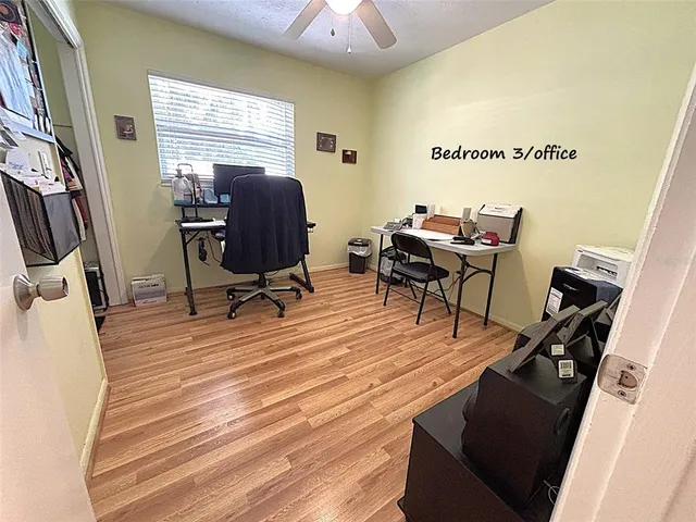 a view of a workspace with furniture and a window
