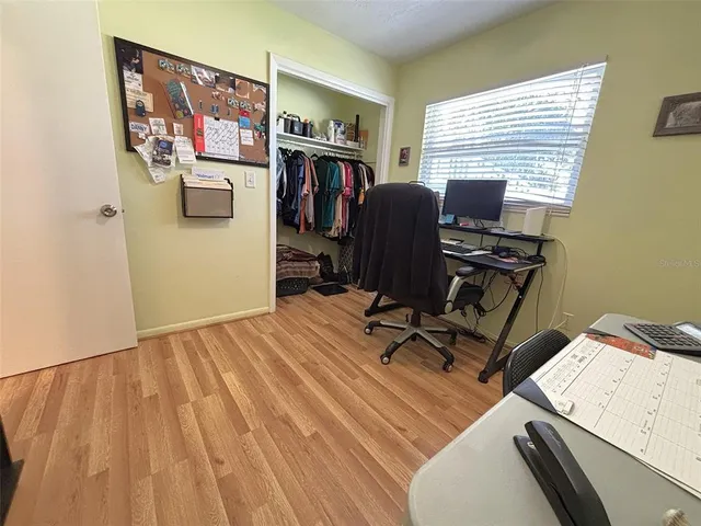 a view of workspace with wooden floor windows