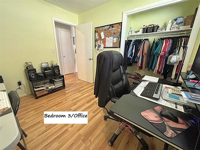 a view of a workspace with furniture and book shelf