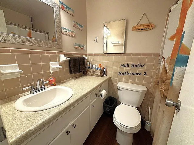 a bathroom with a toilet sink and mirror