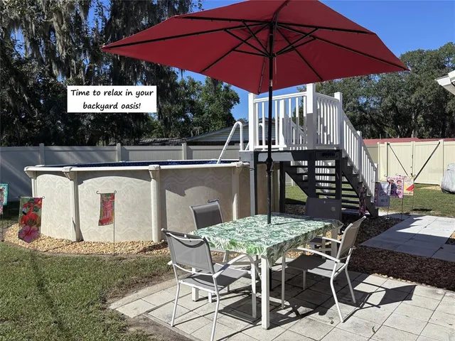 a view of backyard with seating space and trees