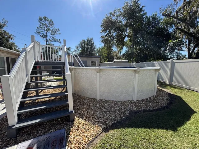 a view of a door with furniture and wooden floor