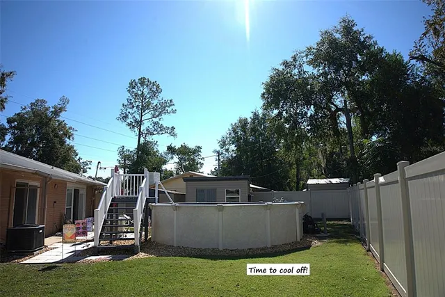 a view of a house with a backyard