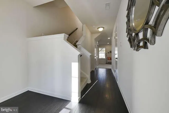a view of a hallway with wooden floor