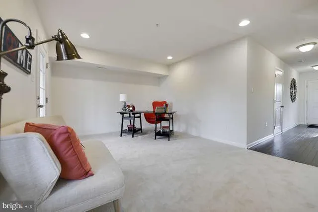 a living room with furniture and a chair