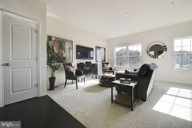 a living room with furniture a fireplace and a large window