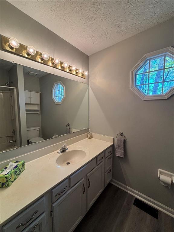 4949 Penscot Way Stone Mountain, GA 30088 - Photo 24 of 40 a bathroom with a sink a mirror and a toilet