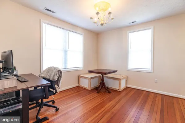 a view of a workspace with furniture and a window