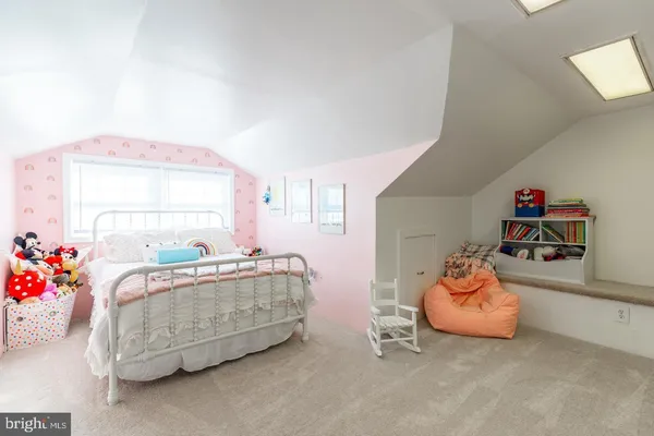 a bedroom with furniture and a window