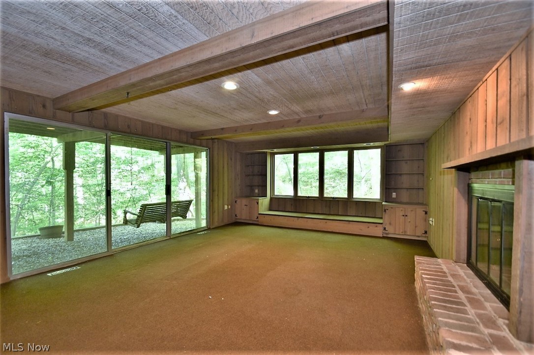 4152 Giles Road Chagrin Falls, OH 44022 - Photo 21 of 31 Lower level family with fireplace, paneling, built-ins and sliders to patio