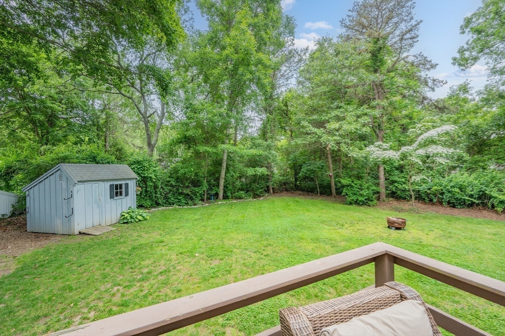 52 Mill Road East Sandwich, MA 02537 - Photo 32 of 36 a view of a backyard with a garden and deck