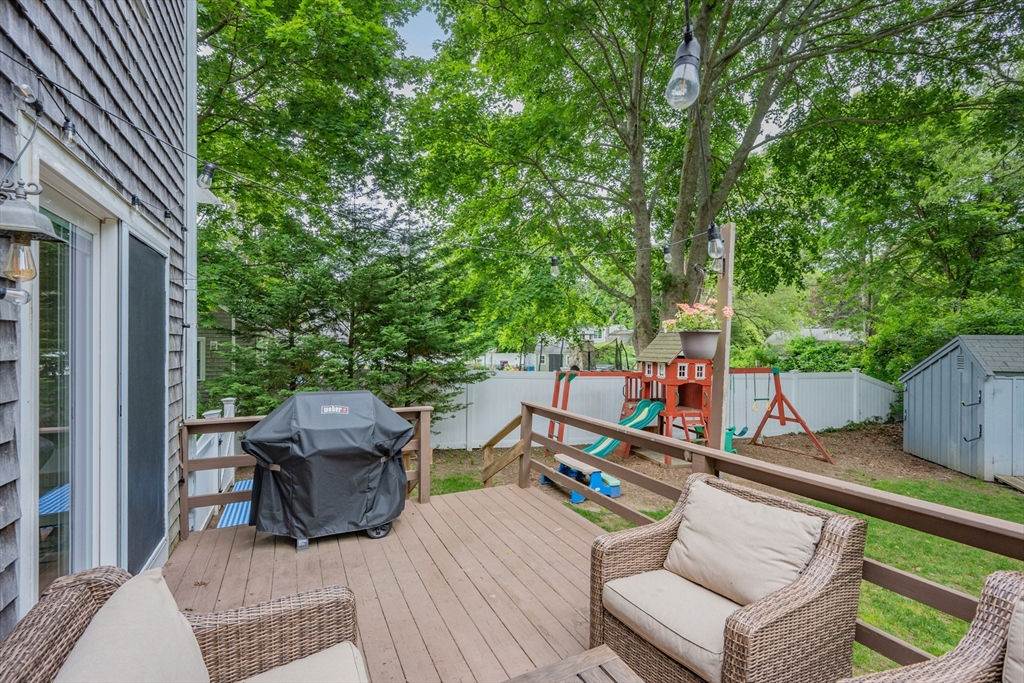 52 Mill Road East Sandwich, MA 02537 - Photo 33 of 36 a view of a patio with lawn chairs next to a yard