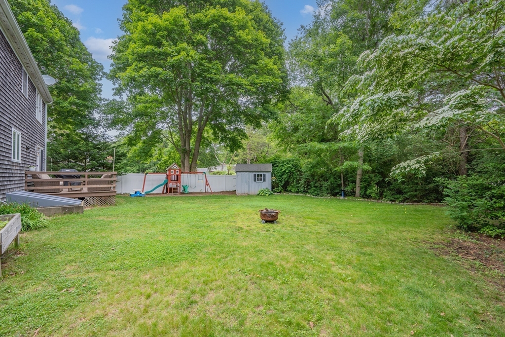 52 Mill Road East Sandwich, MA 02537 - Photo 4 of 36 a view of backyard with a barn and large trees