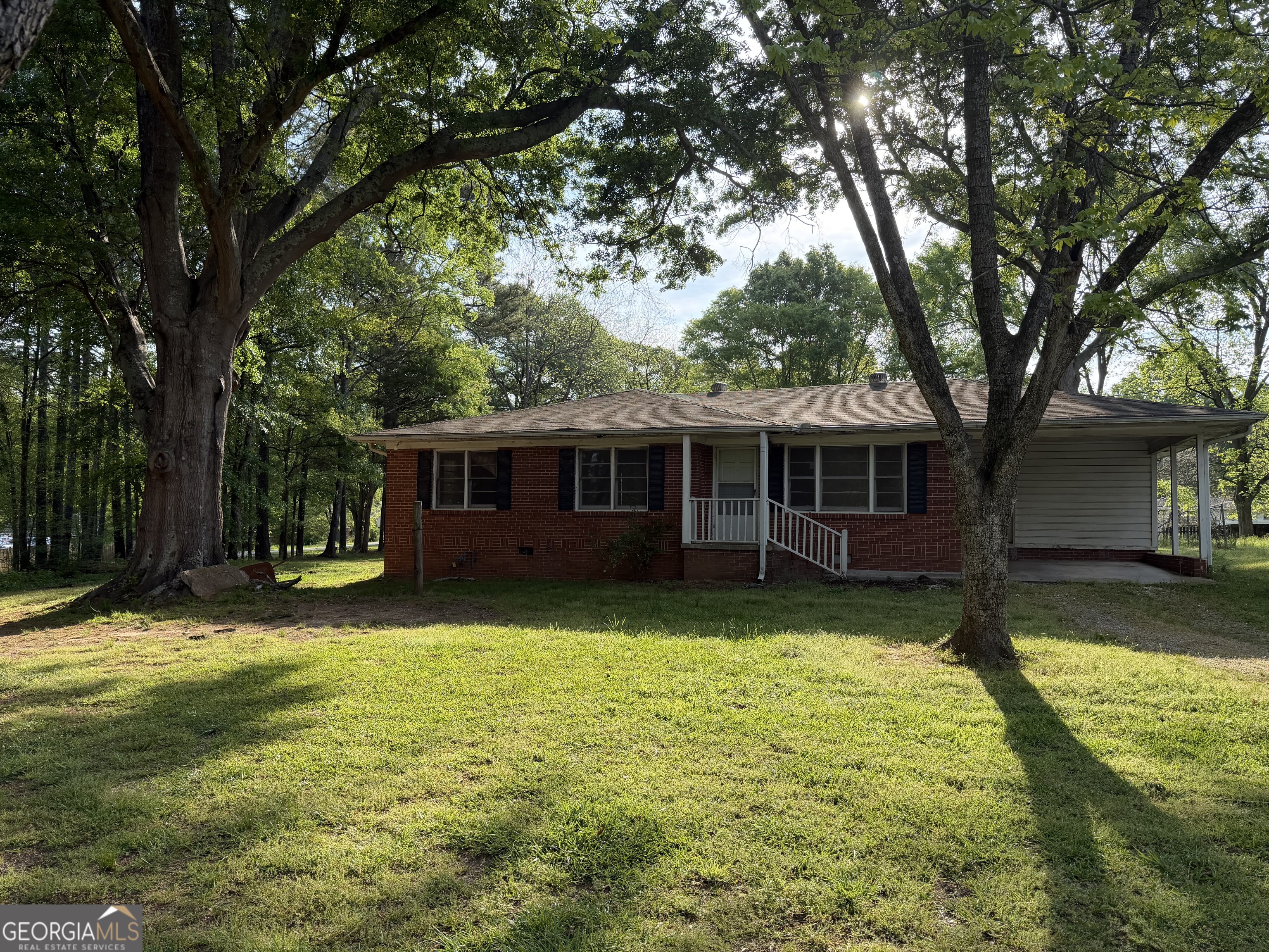 321 S Highway Covington, GA 30016 - Photo 1 of 1 a view of a yard in front of a house with large trees