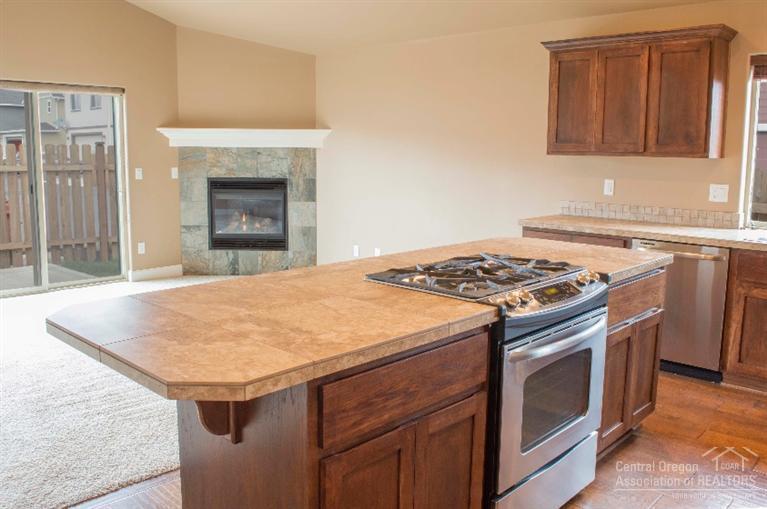 61723 Rigel Way Bend, OR 97702 - Photo 9 of 17 a kitchen with granite countertop a stove and a sink