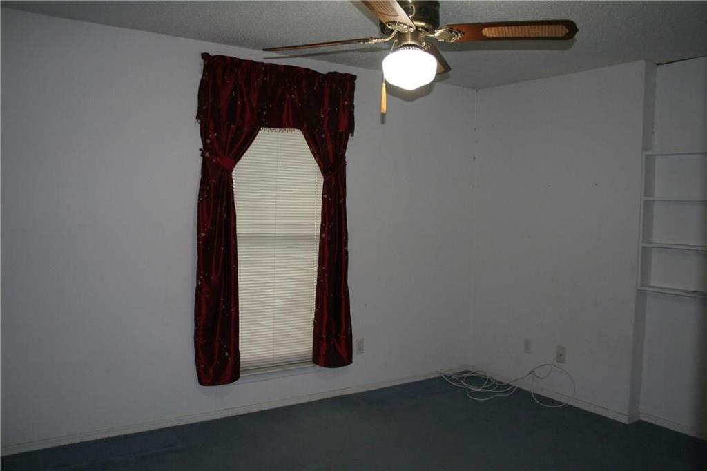 2107 Forest Grove Estates Road Allen, TX 75002 - Photo 12 of 13 Carpeted empty room with baseboards and a ceiling fan