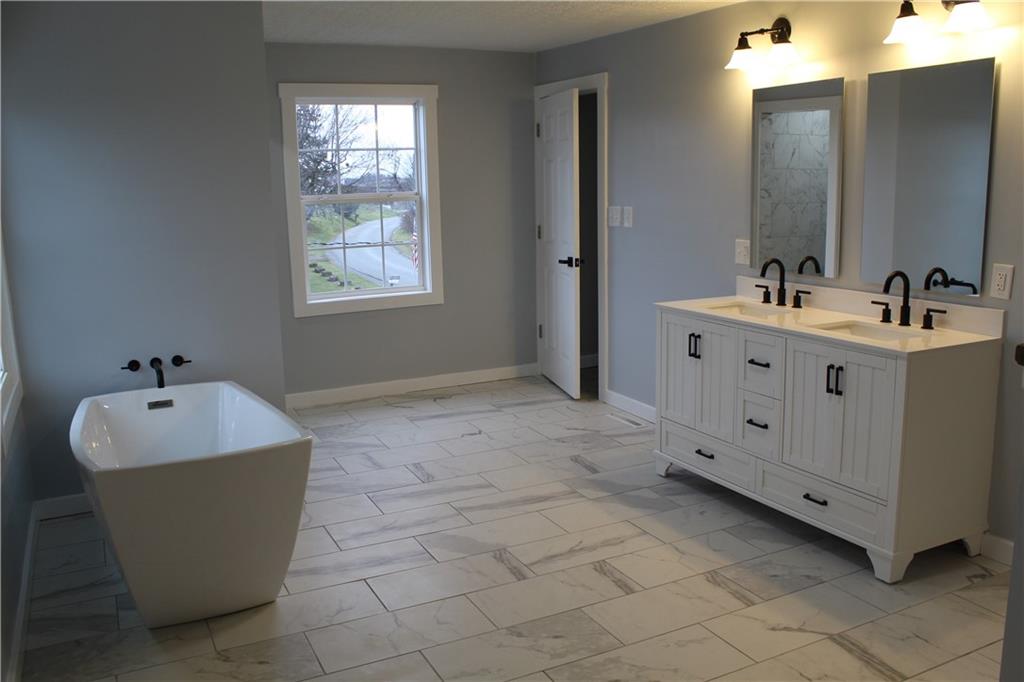 73 Beham Ridge Road West Alexander, PA 15376 - Photo 6 of 20 a spacious bathroom with a bathtub sink and mirror