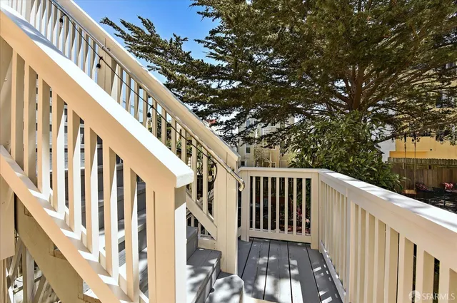 a view of staircase with wooden floor and fence