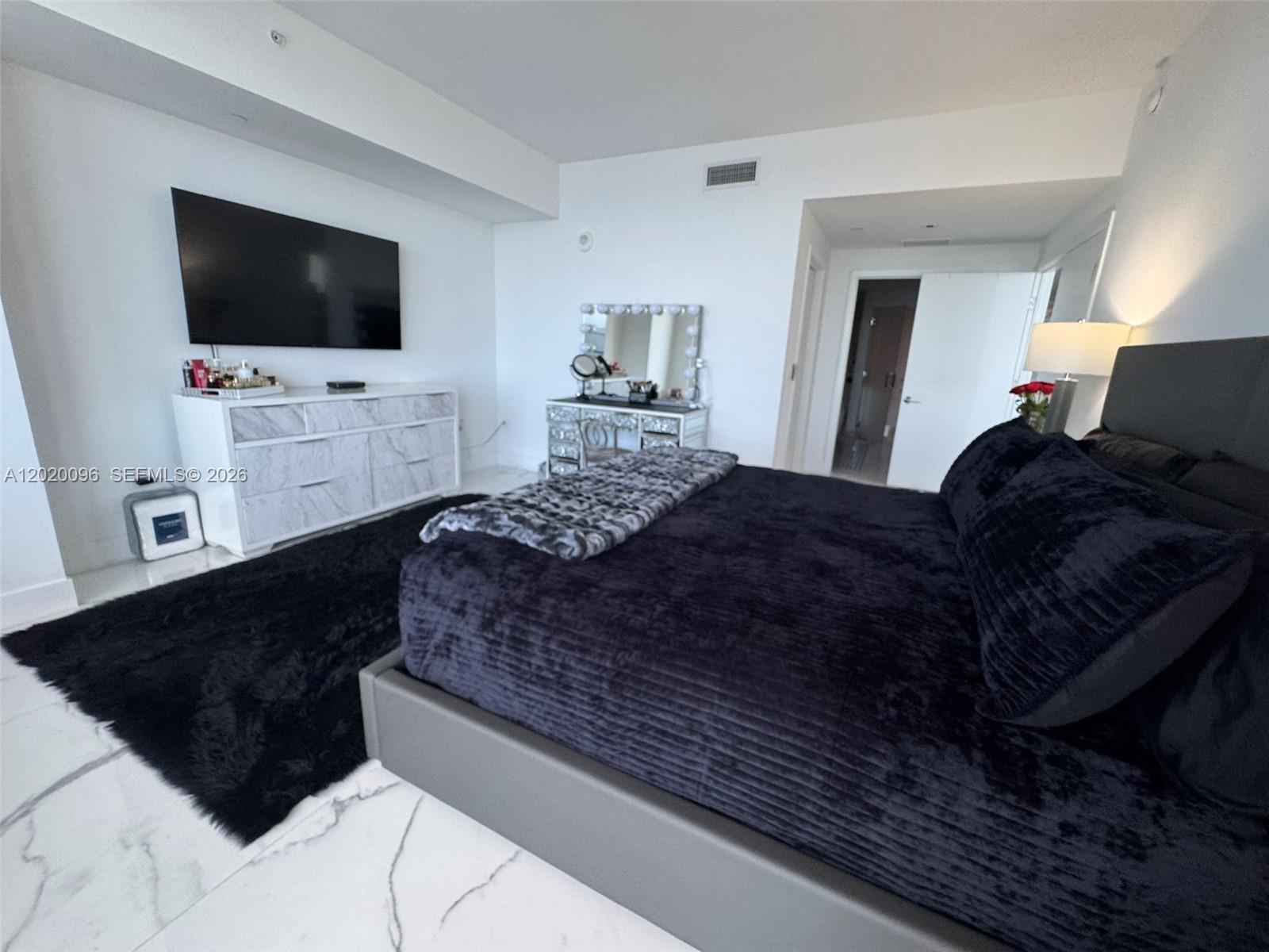 788 Northeast 23rd Street, Unit 1202 Miami, FL 33137 - Photo 18 of 64 a living room with furniture and a flat screen tv
