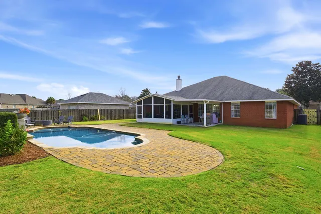 a front view of a house with yard and green space