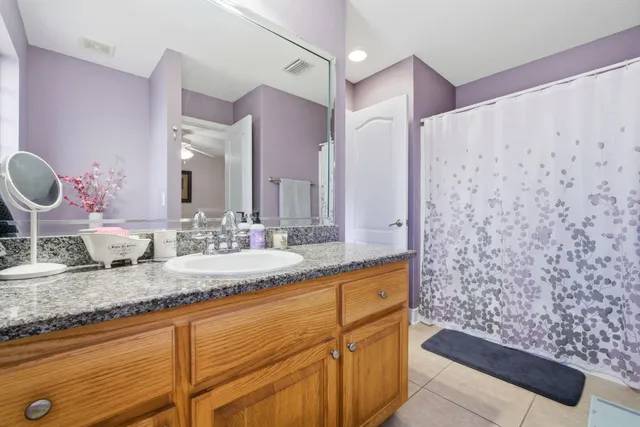 a spacious bathroom with a tub shower and a sink