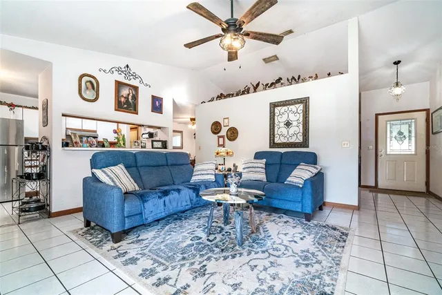 a living room with fireplace furniture and a rug