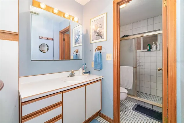 a bathroom with a sink a mirror and a shower