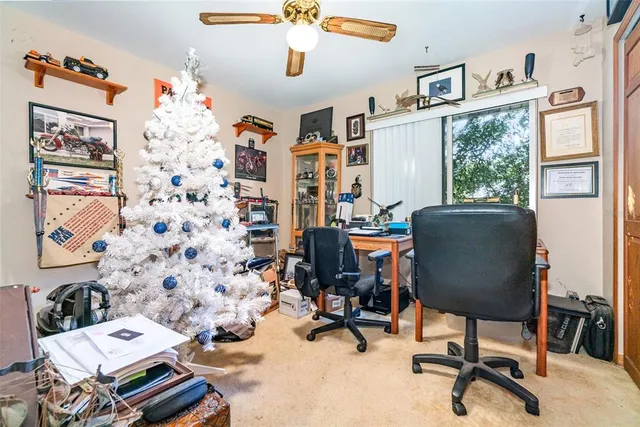 a view of a workspace with furniture and a window