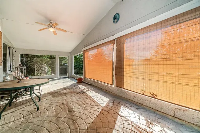 a view of a room with a table and chairs