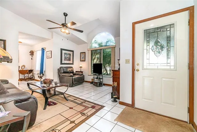 a living room with furniture a chandelier and a window