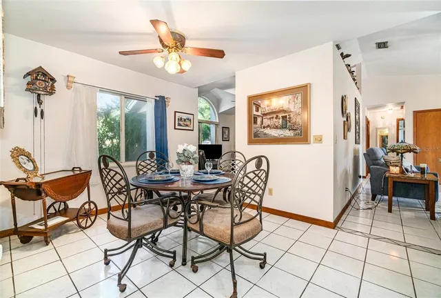 a view of a livingroom with furniture and a dining table