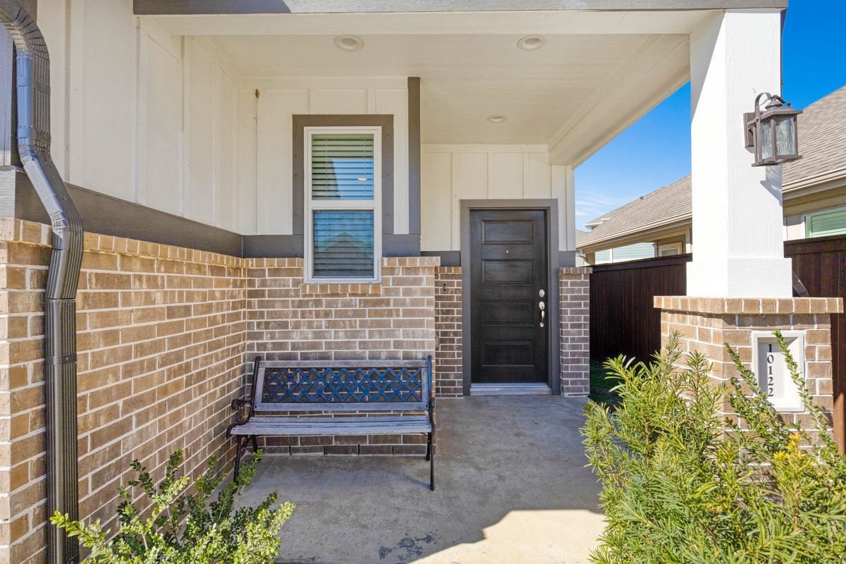 10122 Crescendo Way Manvel, TX 77578 - Photo 3 of 24 a brick building with a bench in front of it