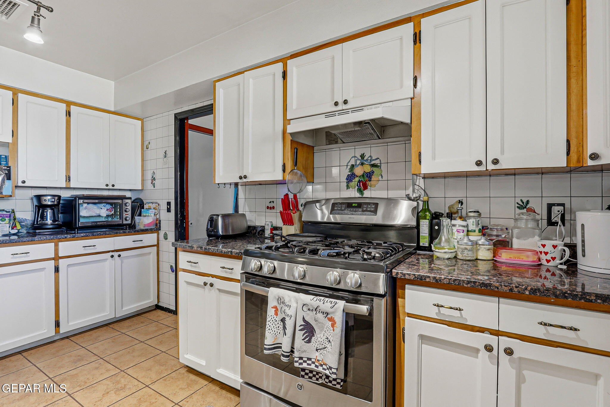 1602 Waterfront Street Anthony, NM 88021 - Photo 14 of 58 a kitchen with stainless steel appliances granite countertop a stove a sink and white cabinets