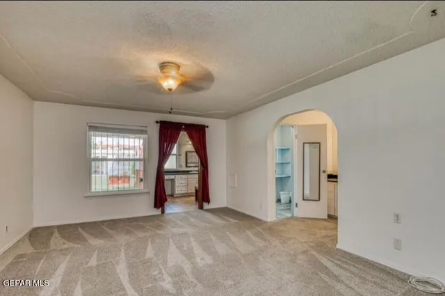a bathroom with a granite countertop bathtub a sink and a window