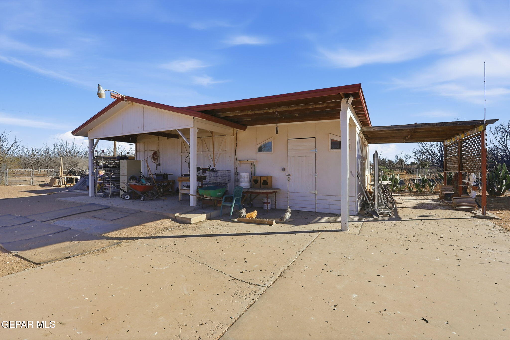 1602 Waterfront Street Anthony, NM 88021 - Photo 47 of 58 a patio with a table and chairs under an umbrella