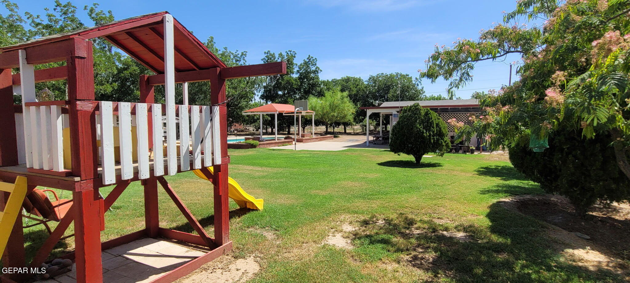 1602 Waterfront Street Anthony, NM 88021 - Photo 48 of 58 a view of a backyard with sitting area and slide