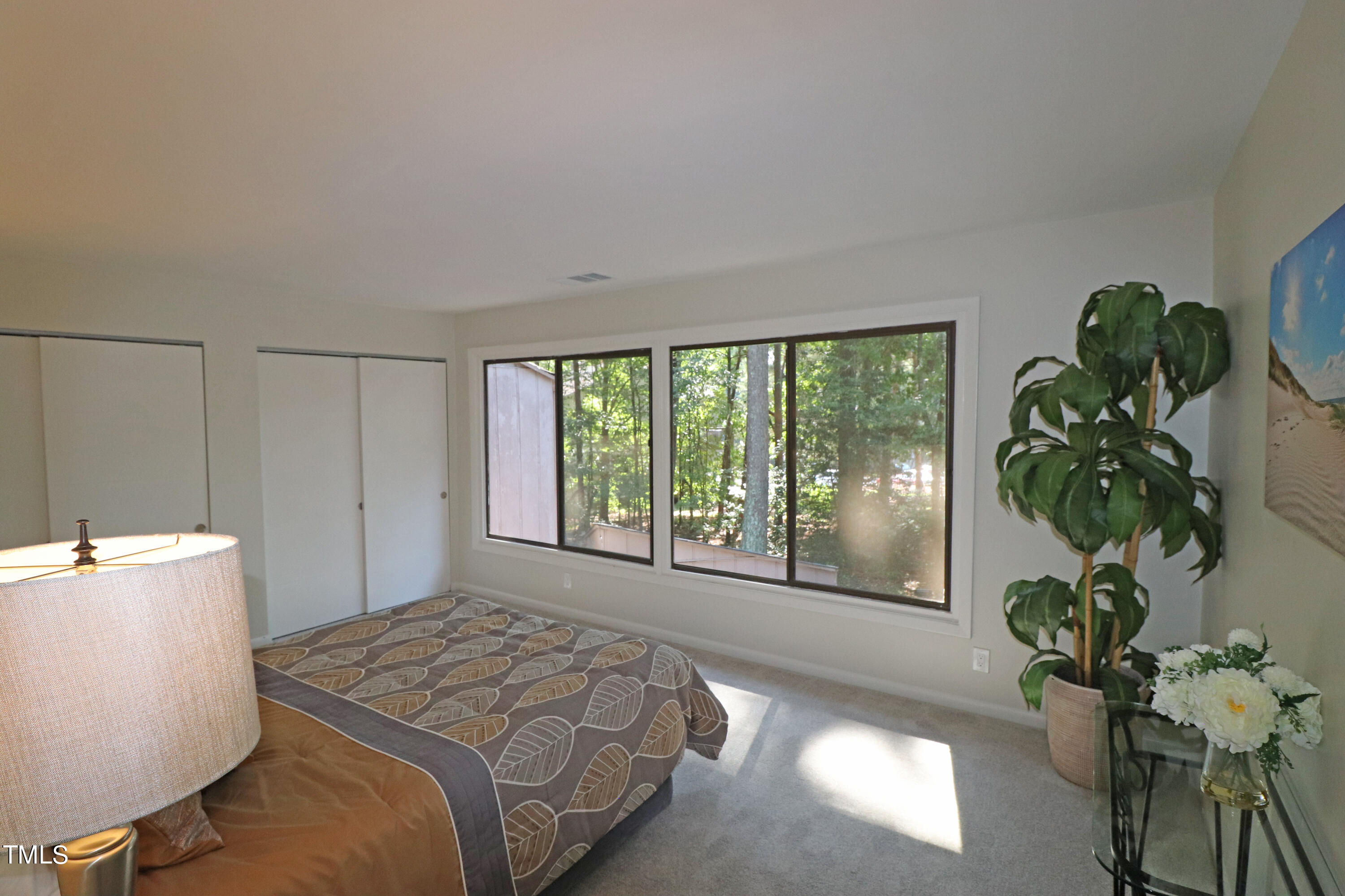 1716 Quail Ridge Road Raleigh, NC 27609 - Photo 26 of 39 a bedroom with a bed and a large window
