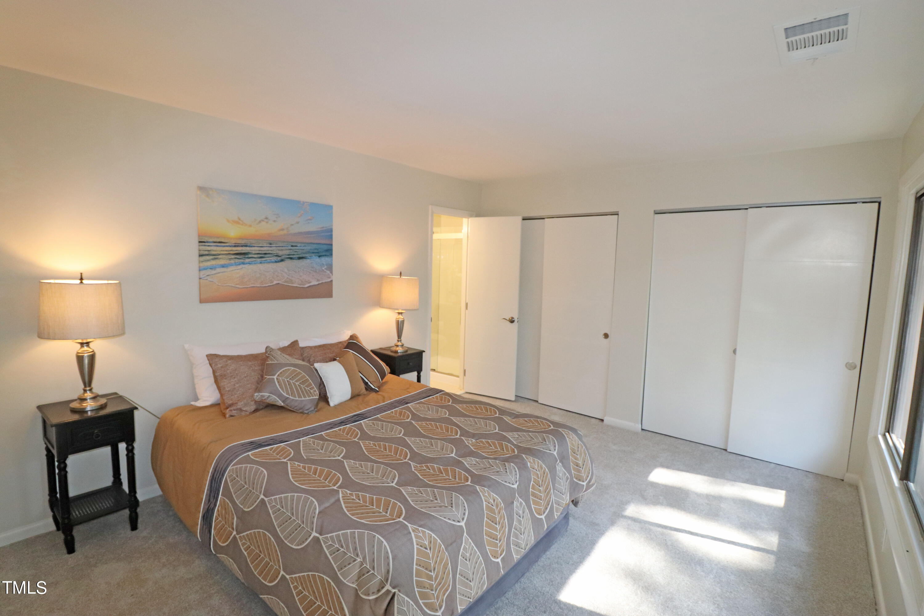 1716 Quail Ridge Road Raleigh, NC 27609 - Photo 28 of 39 a bedroom with a bed and a lamp