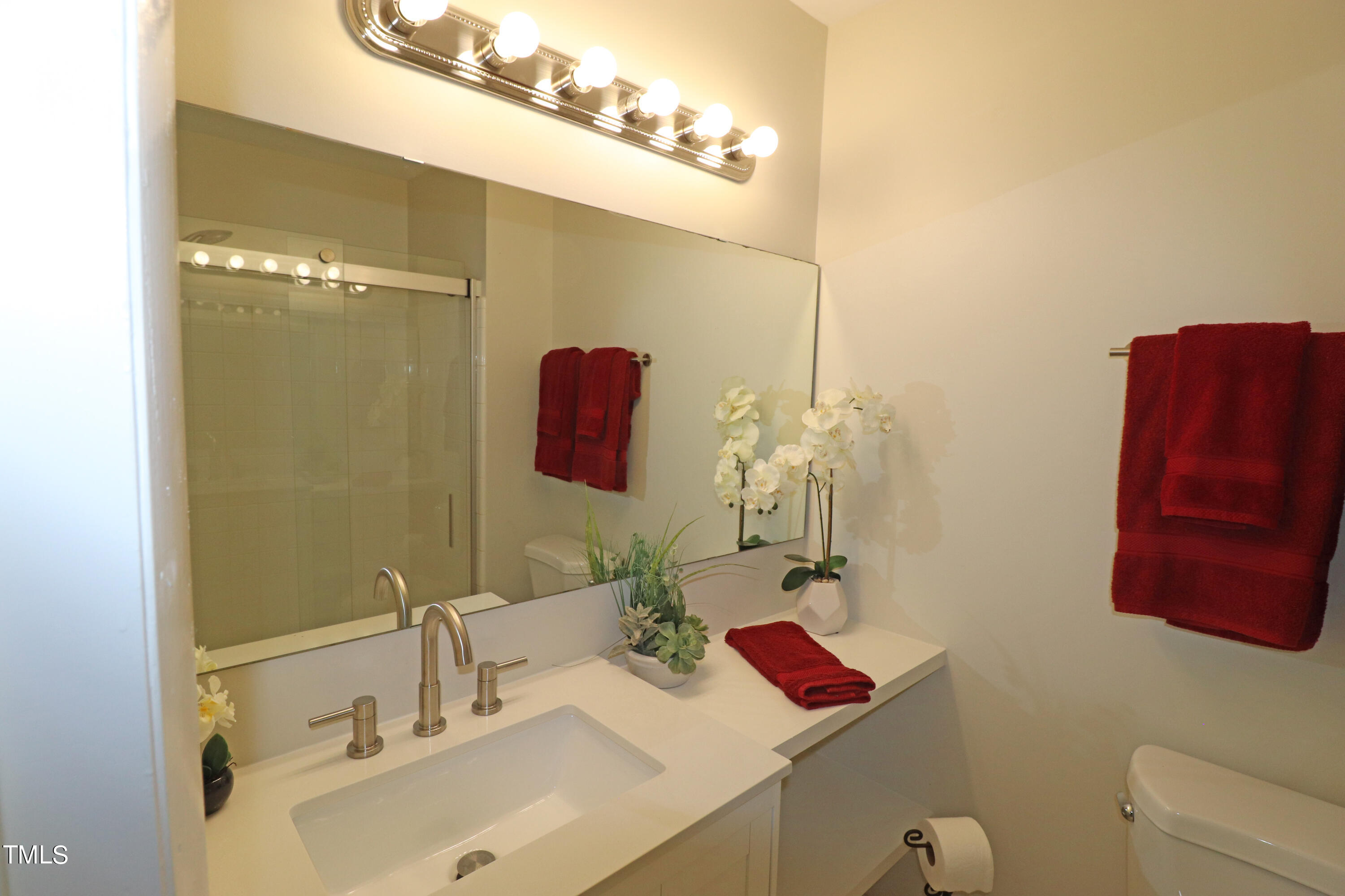 1716 Quail Ridge Road Raleigh, NC 27609 - Photo 29 of 39 a bathroom with a sink and a mirror
